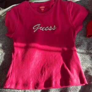 Pink Guess shirt with the Guess logo in the front